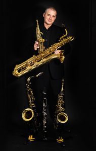 Andy Firth holding saxes