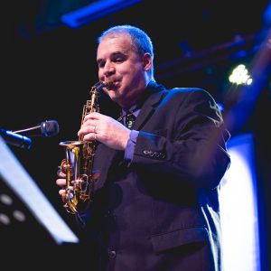 Andy Firth play a curved soprano saxophone live on stage
