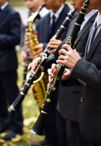 A row of students playing clarinets