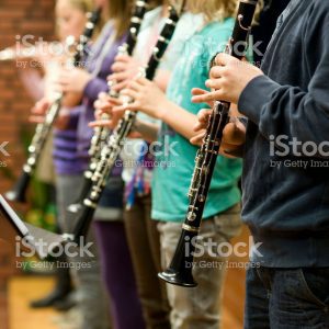 A row of students playing clarinets
